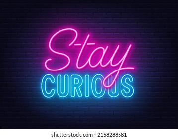 Stay Curious neon lettering on brick wall background.