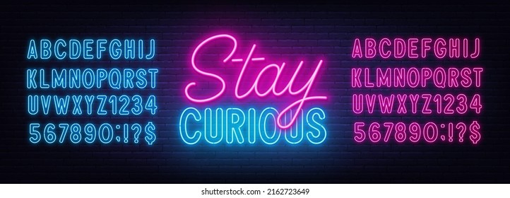 Stay Curious neon lettering on brick wall background.