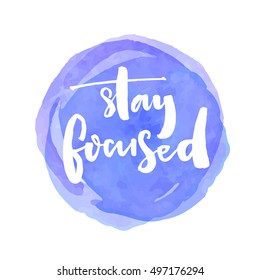 Stay focused. Motivation quote about productivity and concentration on the work and learning. White vector brush lettering saying at blue watercolor stain. svg