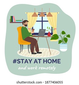 Stay at home concept. Man with coffee sitting at a table with laptop in room interior and correspondence surfing the Internet. Male stay at home keeping the distance. Quarantine or self-isolation
