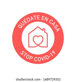 Stay at home to stop coronavirus written in Spanish. Round symbol to prevent Covid-19.