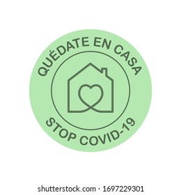 Stay at home to stop coronavirus written in Spanish. Round symbol to prevent Covid-19.