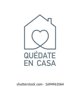 Stay at home written in Spanish. Symbol to prevent and stop Covid-19.