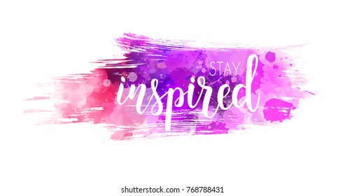 Stay inspired hand lettering phrase on watercolor imitation color splash.  Modern calligraphy inspirational quote. Vector illustration.