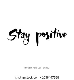 Stay positive. Calligraphy monochrome poster. Positive hand written quote isolated on white background.