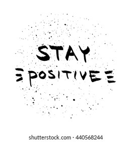 Stay Positive lettering. Motivational quote on blurred background.
