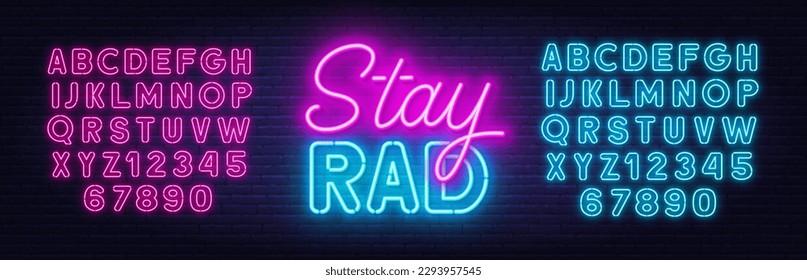 Stay Rad neon quote on brick wall background.