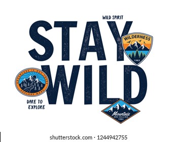 Stay wild vector slogan graphic, included patches and mountain illustrations.