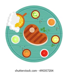 Steak grilled on a wooden tray with sauces and spices.