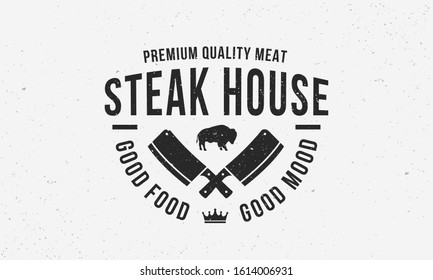 Steak House vintage logo design. Label for BBQ, Restaurant, Meat store, Butchery. Vintage typography with buffalo and crossed meat cleavers. Vector template.