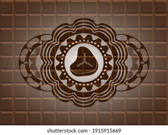 Steak icon inside chocolate bar emblem. Brown classic background. Artistic illustration. 