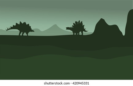 stegosaurus in fields scenery silhouette with green backgrounds
