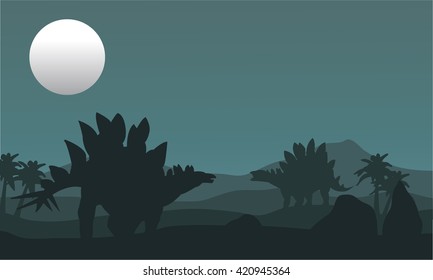 stegosaurus and moon silhouette at the night