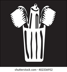 stencil toothpaste and toothbrush in a glass on a black background