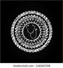 stethoscope icon inside chalk emblem written on a blackboard