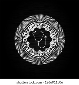 stethoscope icon inside chalkboard emblem