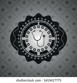 stethoscope icon inside dark badge or emblem