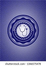 stethoscope icon inside emblem with denim texture