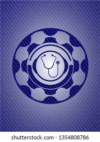 stethoscope icon inside emblem with denim texture