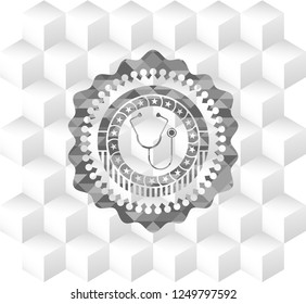 stethoscope icon inside grey badge with geometric cube white background