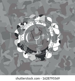 stethoscope icon inside grey camo emblem