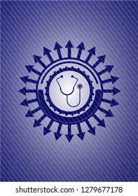 stethoscope icon inside jean or denim emblem or badge background