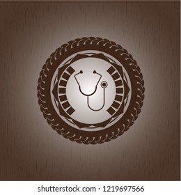stethoscope icon inside realistic wooden emblem