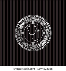 stethoscope icon inside silver emblem
