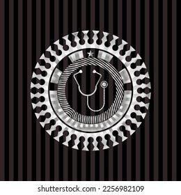 stethoscope icon inside silver emblem. 