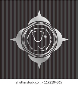 stethoscope icon inside silvery emblem or badge