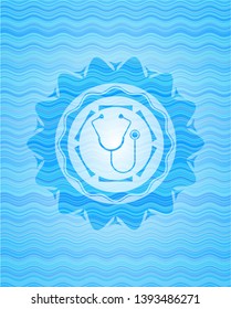 stethoscope icon inside sky blue water emblem.