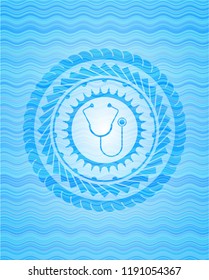 stethoscope icon inside water wave concept style emblem.