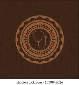 stethoscope icon inside wooden emblem