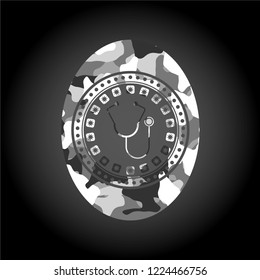 stethoscope icon on grey camo texture