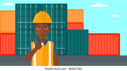 Stevedore standing on cargo containers background.