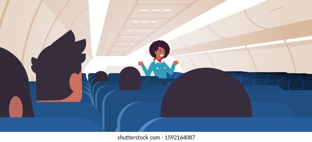 stewardess explaining instructions for passengers african american flight attendant in uniform showing emergency exits safety demonstration concept airplane board interior horizontal vector