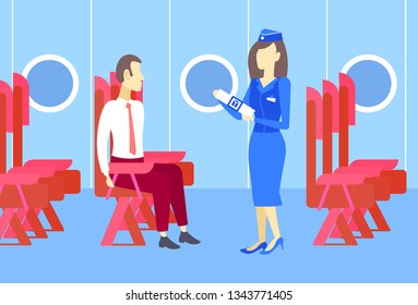 stewardess presenting to business man airplane passenger seat belt fastening explains safety concept modern plane board interior full length horizontal
