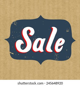 Sticker or badge for sale with hand drawn lettering isolated on brown kraft paper background.