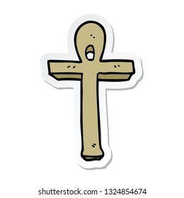 sticker of a cartoon ankh symbol