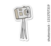 sticker of a cartoon camera on tripod