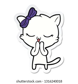 sticker of a cartoon cat with bow on head