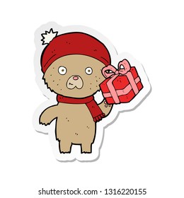 sticker of a cartoon christmas teddy bear with present