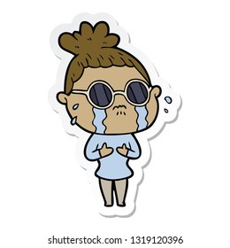 sticker of a cartoon crying woman wearing dark glasses