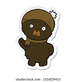 sticker of a cartoon cute black bear in winter hat and scarf