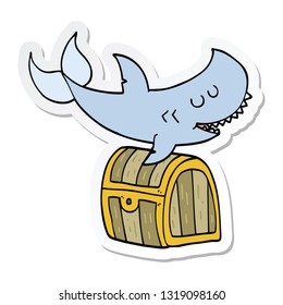 sticker of a cartoon shark swimming over treasure chest