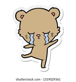 sticker of a crying cartoon bear balancing
