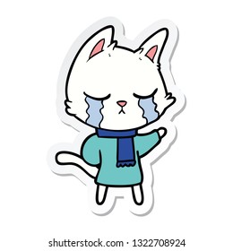sticker of a crying cartoon cat wearing winter clothes