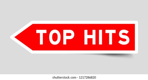 Sticker in red color arrow shape with word top hits on gray background