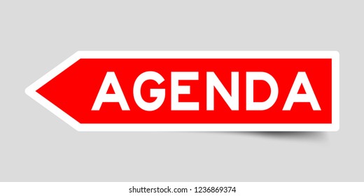 Sticker in red color arrow shape with word agenda on gray background