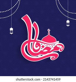 Sticker Style Pink Ramadan Calligraphy In Arabic Language With Mosque Dome And Lamps Hang On Blue Mandala Pattern Background.